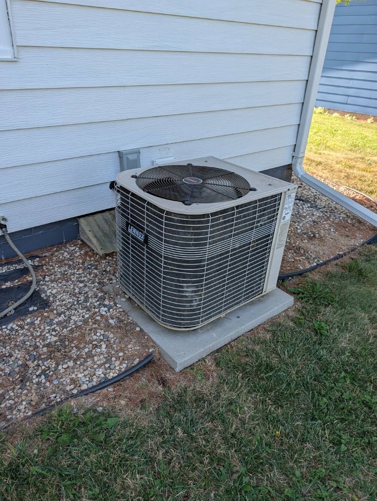 Worn-out air conditioner condenser before replacement in Perry, Iowa