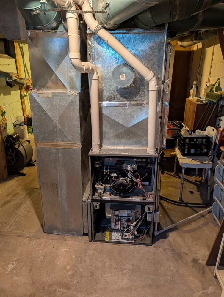 Aging furnace and ductwork before a Hulgan HVAC upgrade in Perry, Iowa