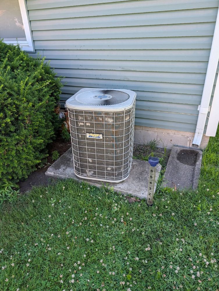 Old rusted air conditioner before replacement in Perry, Iowa